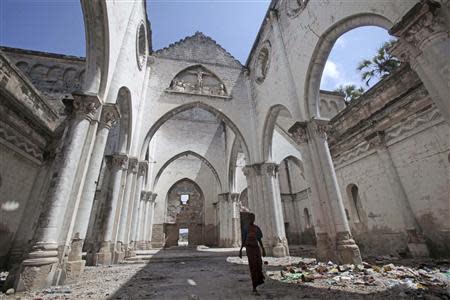 A boy stands inside a destroyed church in the Hamerweyne district of Mogadishu September 26, 2013. REUTERS/Feisal Omar