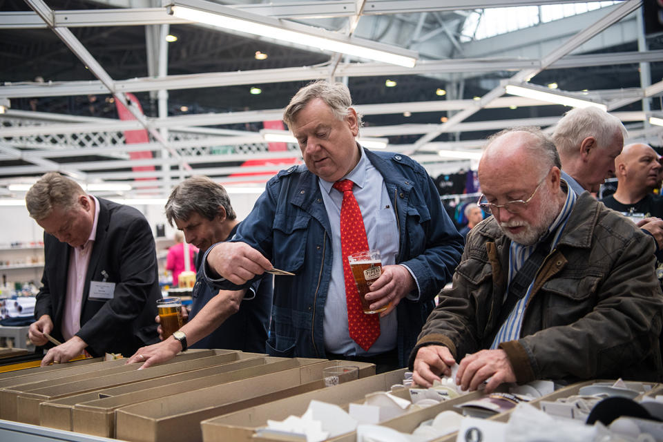 <p>Beer mat collectors browse mats for sale at the CAMRA (Campaign for Real Ale) Great British Beer festival at Olympia exhibition center on August 8, 2017 in London, England. (Photo: Carl Court/Getty Images) </p>