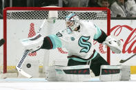 Seattle Kraken goaltender Chris Driedger deflects a shot during the first period of an NHL hockey game against the Los Angeles Kings Monday, March 28, 2022, in Los Angeles. (AP Photo/Mark J. Terrill)