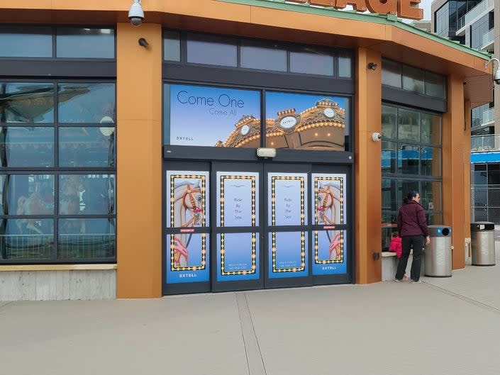 A child looks in at Long Branch's merry-go-round, which remains closed.