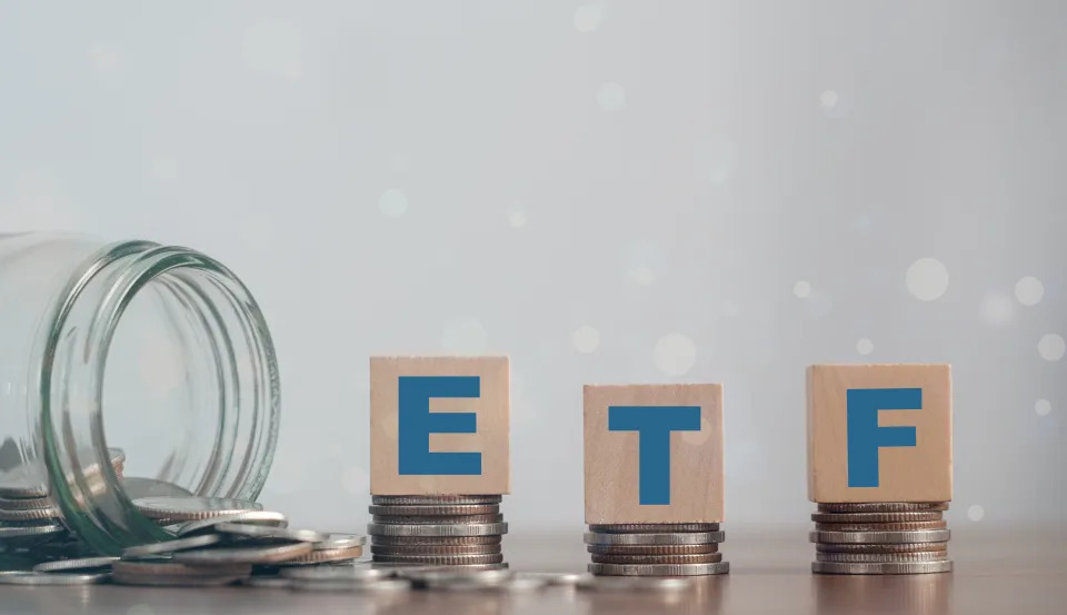 ETF (Exchange Traded Fund), business/finance. Wooden cubes with the letters ETF arranged in a vertical pyramid. ETF - short for Exchange-Traded Fund, business concept.