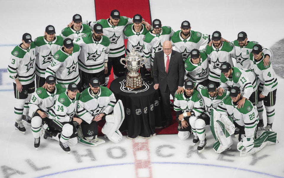 Members of the Dallas Stars pose with the Clarence Campbell Bowl, awarded to the NHL's Western Conference champions, after defeating the Vegas Golden Knights in overtime NHL Western Conference final playoff game action in Edmonton, Alberta, Monday, Sept. 14, 2020. (Jason Franson/The Canadian Press via AP)