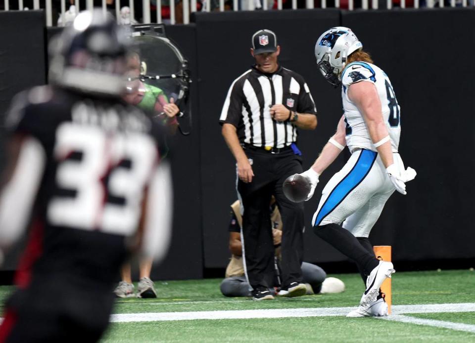 Carolina Panthers tight end Hayden Hurst holds out the ball as he crosses the goal line for a touchdown during second quarter action against the Atlanta Falcons at Mercedes-Benz Stadium in Atlanta, GA on Sunday, September 10, 2023.