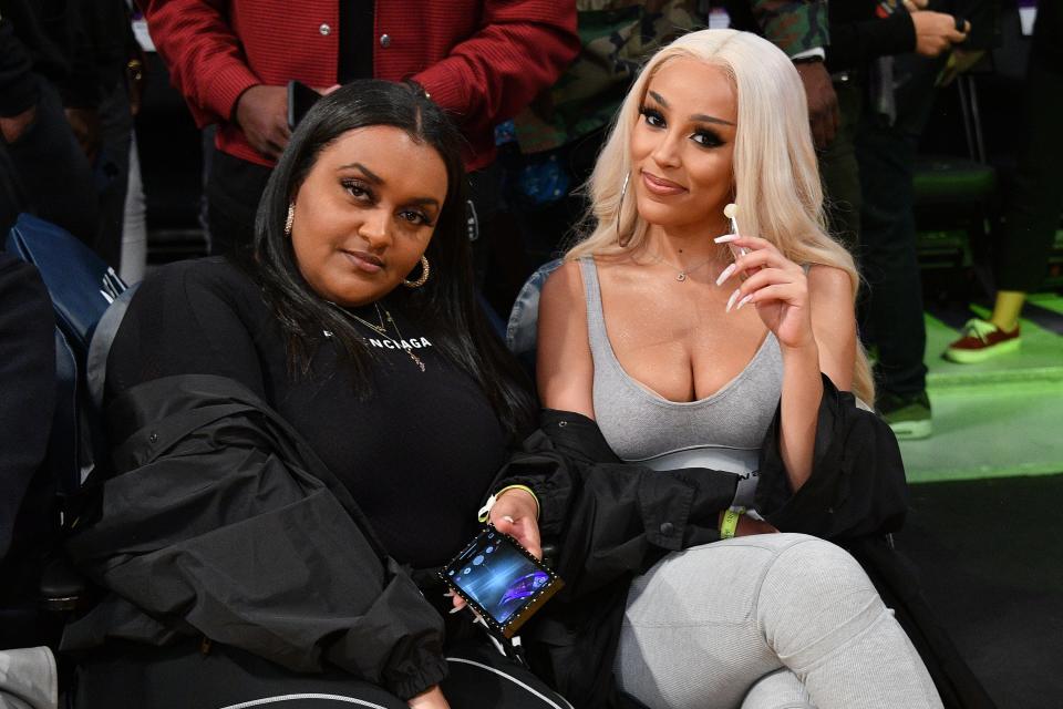 Doja Cat (R) attends a basketball game between the Los Angeles Lakers and the Brooklyn Nets at Staples Center on March 10, 2020 in Los Angeles, California.