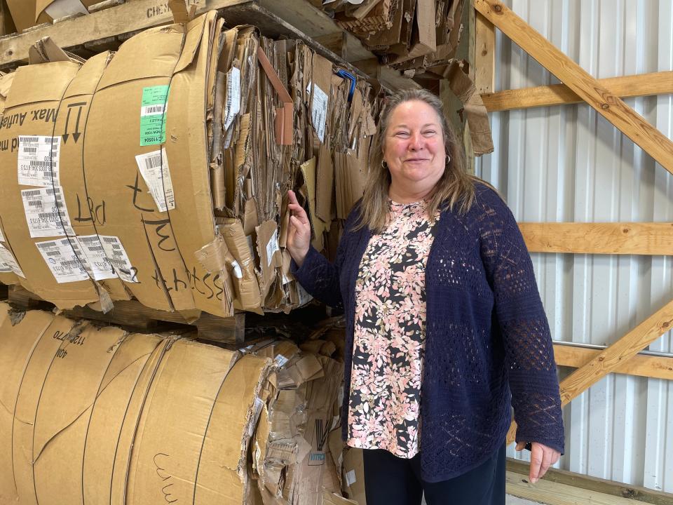 Recycle Livingston Executive Director Julie Cribley stands near bails of cardboard in a newly constructed building in Howell on Wednesday, Oct. 18, 2023.