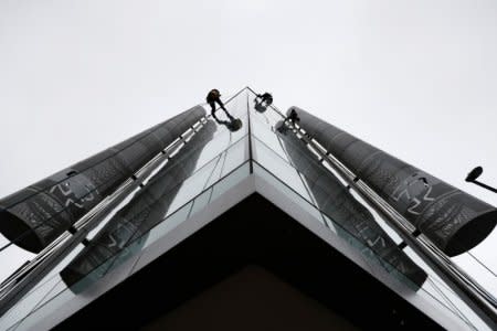 FILE PHOTO: Window cleaners work outside the offices of Cambridge Analytica in central London, Britain, March 24, 2018. REUTERS/Peter Nicholls