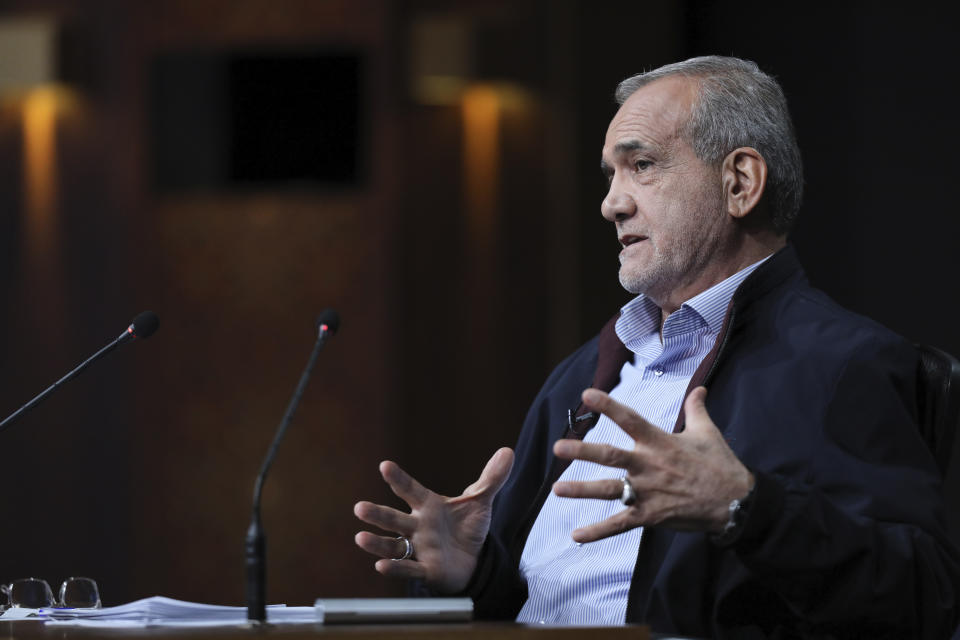 In this photo made available by Iranian state-run TV, IRIB, Iranian presidential candidate reformist Masoud Pezeshkian speaks during a debate with hard-line candidate Saeed Jalili at the TV studio in Tehran, Iran, Monday, June 1, 2024. (Morteza Fakhri Nezhad/IRIB via AP)