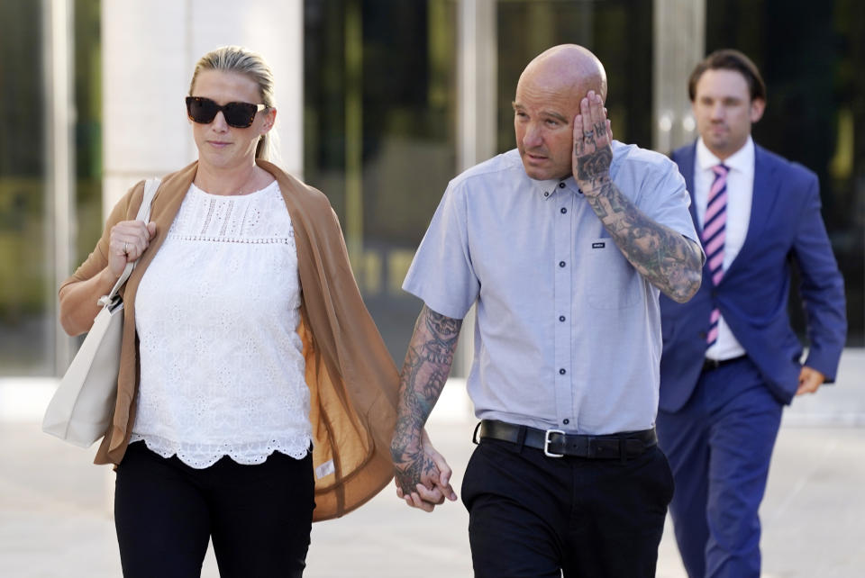 Kevin Michael Brophy and his wife Lindsay leave federal court as proceedings continue in his $5 million copyright infringement lawsuit against pop star Cardi B, Wednesday, Oct. 19, 2022, in Santa Ana, Calif. Brophy is suing the Grammy-winning musician for allegedly misusing his likeness for her sexually suggestive mixtape cover art in 2016. (AP Photo/Chris Pizzello)