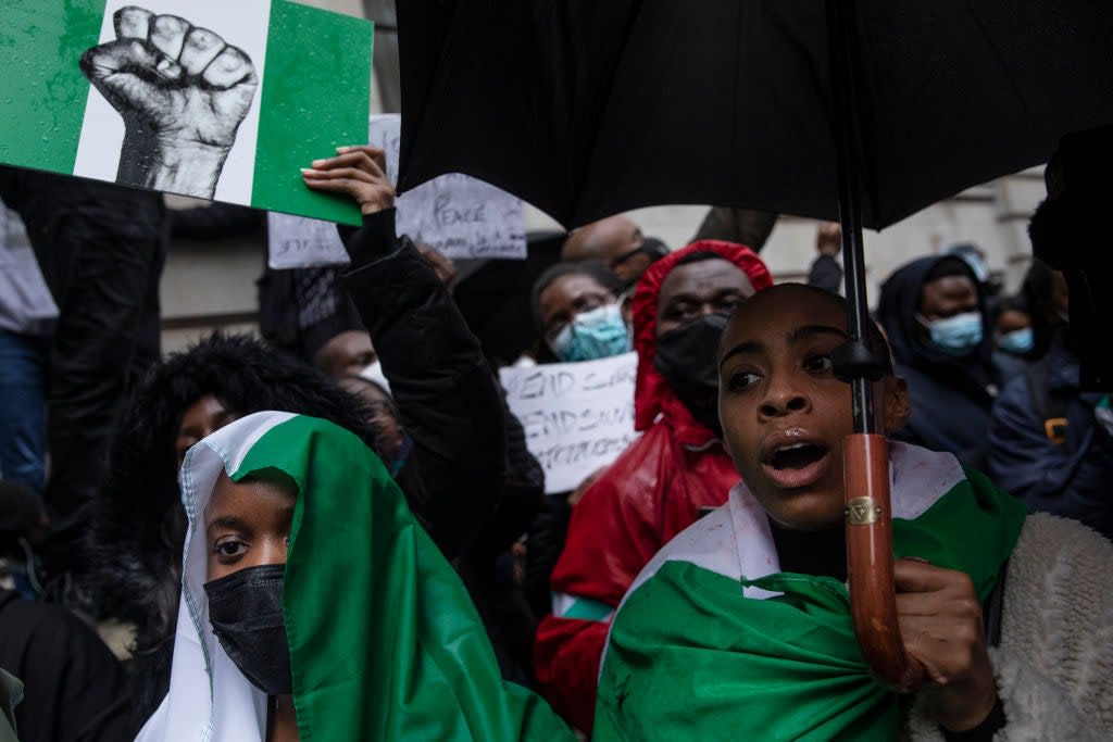 Protesters hold placards and signs calling for the end of police killings of the public in Nigeria, during a demonstration in London (Getty Images)