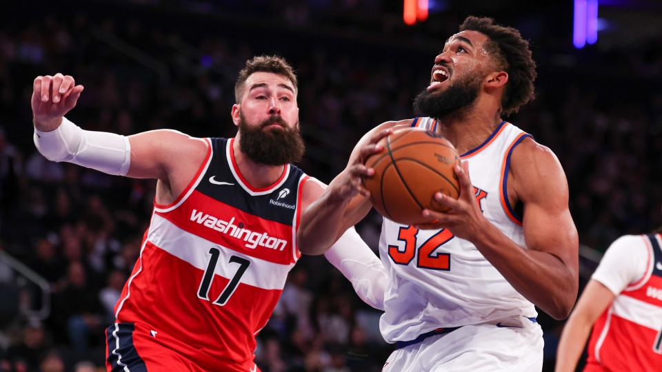 New York, New York, USA; New York Knicks center Karl-Anthony Towns (32) drives to the basket against Washington Wizards center Jonas Valanciunas (17) during the second half at Madison Square Garden. 