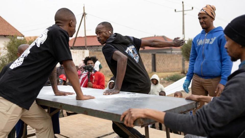 A contestant prepares to deliver a blow during a slap fighting competition in Kagiso township, west of Johannesburg, South Africa August 4, 2024