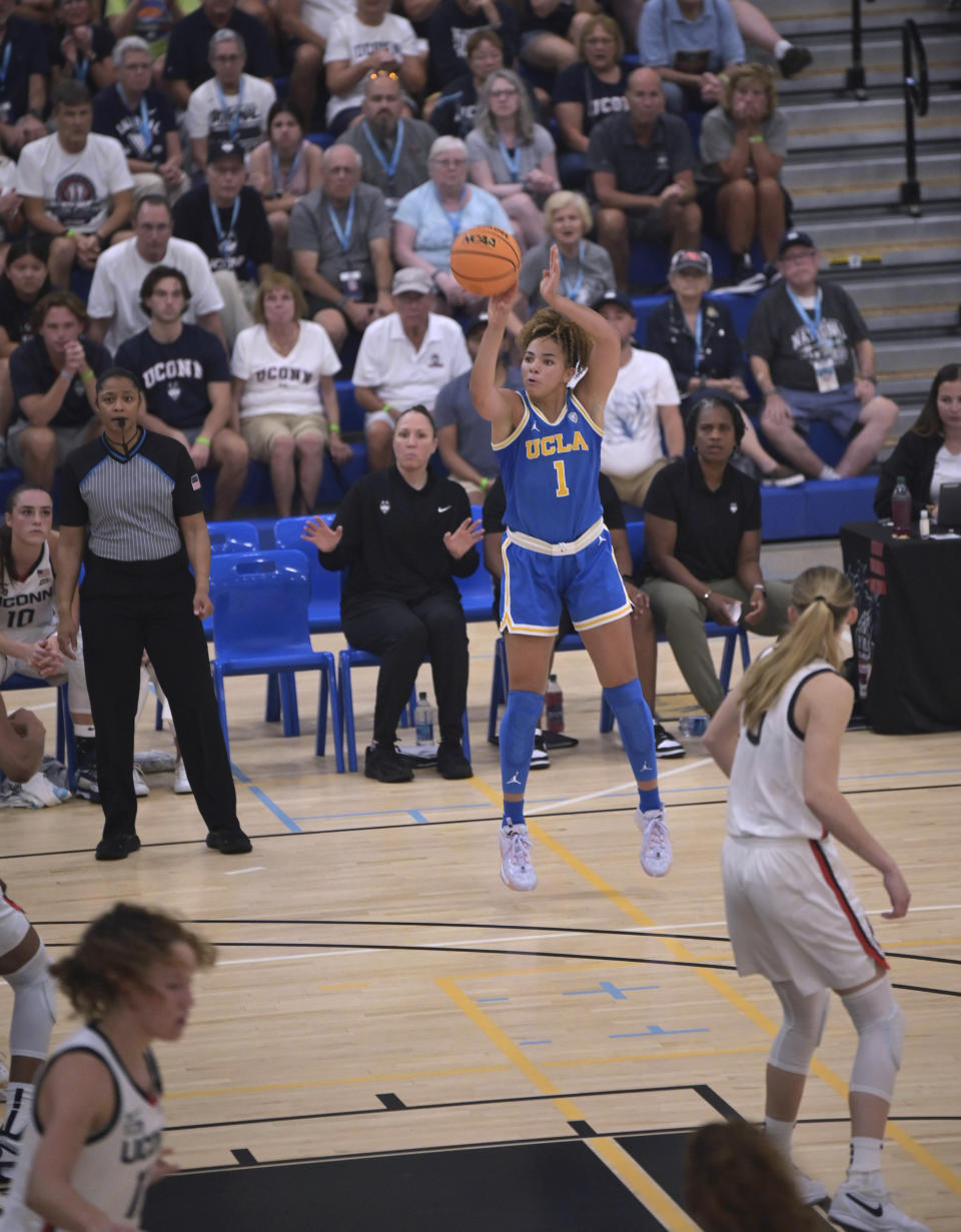 UCLA's Kiki Rice (1) shoots against UConn during the first half of an NCAA college basketball game at the Cayman Islands Classic in George Town, Cayman Islands, Friday, Nov. 24, 2023. (AP Photo/Kevin Morales)