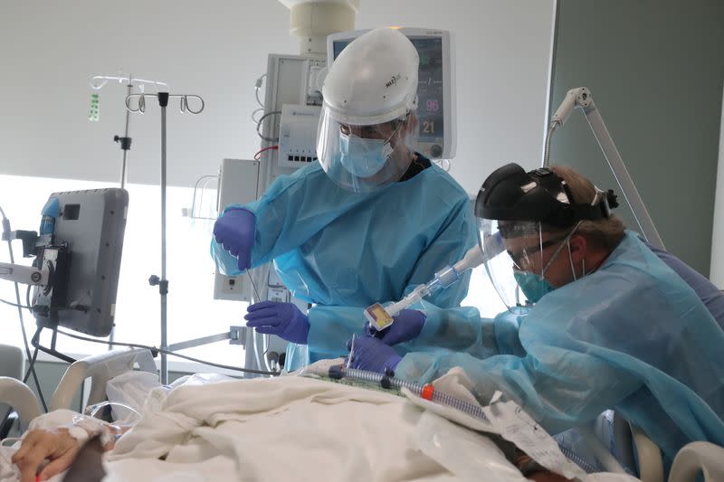 Dr. Gabriel Gomez, 40, intubates a coronavirus disease (COVID-19) patient in the COVID-19 ICU at Providence Mission Hospital in Mission Viejo