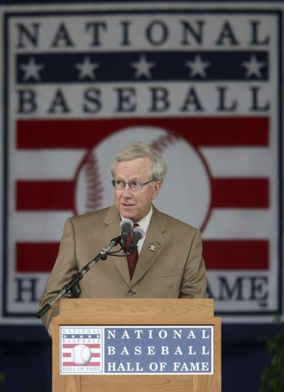 St. Louis Post-Dispatch baseball writer Rick Hummel gives his acceptance speech after receiving the J. G. Taylor Spink award during the Baseball Hall of Fame Induction Ceremony at the Clark Sports Center in Cooperstown, NY., on July 29, 2007. Hummel, an esteemed writer who covered the St. Louis Cardinals and Major League Baseball for five decades for the Post-Dispatch until his retirement in 2022, died Saturday, May 20, 2023, after a short, unspecified illness the Post-Dispatch said Monday. He was 77. (Chris Lee/St. Louis Post-Dispatch via AP)