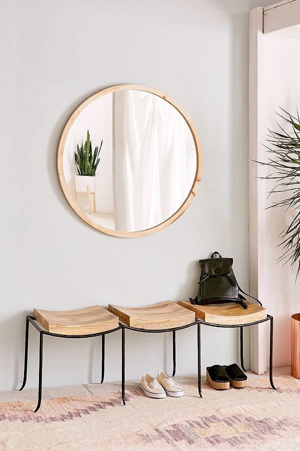 If you're in search of some more seating, <a href="https://www.urbanoutfitters.com/shop/tri-seat-mango-wood-bench?category=furniture&amp;color=020" target="_blank">try this wood tri-bench</a> that can be used against a wall for storage or as an extra sitting area.