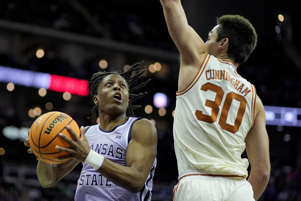 Kansas State guard Dai Dai Ames (4) looks to shoot around Texas forward Brock Cunningham (30) during the first half of an NCAA college basketball game Wednesday, March 13, 2024, in Kansas City, Mo. (AP Photo/Charlie Riedel)