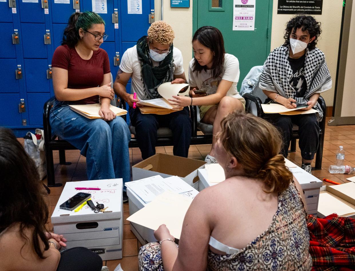 Volunteers help organize and fill out paperwork for those arrested during pro-Palestinian protests at the University of Texas earlier in the day in the lobby of the Travis County Jail, April 24, 2024 in Austin, Texas.