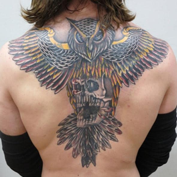 Wanted man: Shane O'Brien has had a tattoo covered up with this owl design (Met Police)