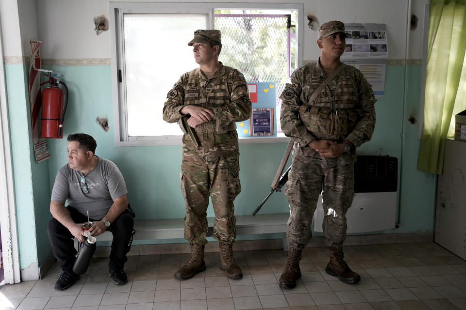 Soldiers guard at a polling station during the presidential runoff election between Javier Milei and Sergio Massa on the outskirts of Buenos Aires, Argentina, Sunday, Nov. 19, 2023. (AP Photo/Rodrigo Abd)