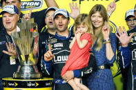 FILE - In this Nov. 17, 2013, file photo, Jimmie Johnson, center, his wife, Chandra, and his daughter, Genevieve, celebrate after he won his sixth NASCAR Sprint Cup Series championship, in Homestead, Fla. Jimmie Johnson is the latest NASCAR superstar to climb out of his car, with the seven-time champion announcing Wednesday, Nov. 20, 2019, that 2020 will be his final season of full-time racing. (AP Photo/Terry Renna, File)