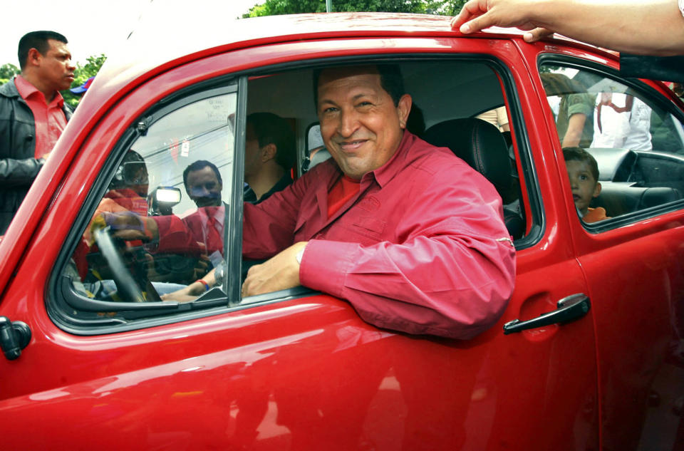 ��Venezuela's President Hugo Chavez drives away in a Volkswagen Beetle after voting in the presidential election, at a school in Caracas in 2006. He received 63% of the vote, well ahead of his rival Manuel Rosales. He won four elections (Reuters)