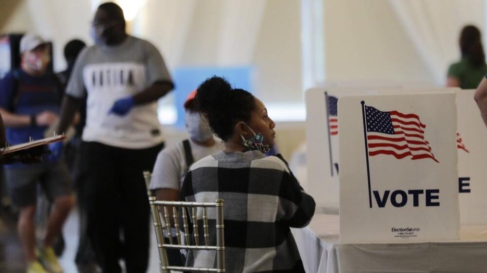 In this June 9, 2020 file photo, people wait to vote in the Georgia’s primary election at Park Tavern in Atlanta. (AP Photo/Brynn Anderson)