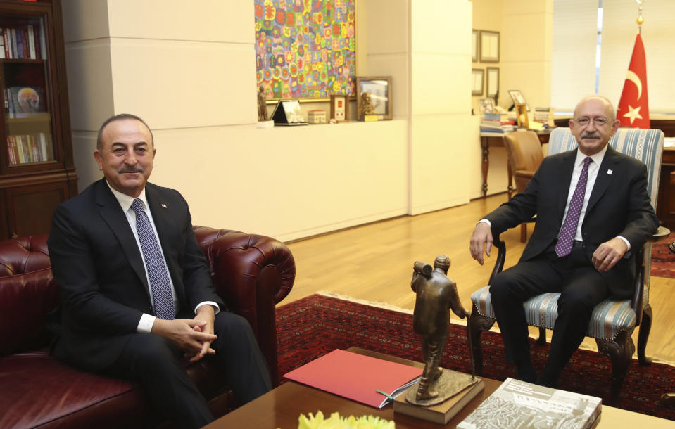 Turkey's Foreign Minister Mevlut Cavusoglu, left, and Kemal Kilicdaroglu, the leader of the main opposition Republican People's Party, CHP, during a meeting, in Ankara, Turkey, Monday, Dec. 30, 2019. The CHP said Monday it does not support the government's plans to deploy troops to Libya, saying the move would embroil Turkey in another conflict and make it a party to the "shedding of Muslims." (AP Photo)