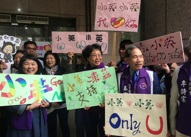 FILE PHOTO: Supporters of Taiwan's President Tsai Ing-wen wait for her arrival to formally register her candidacy for the election, in Taipei