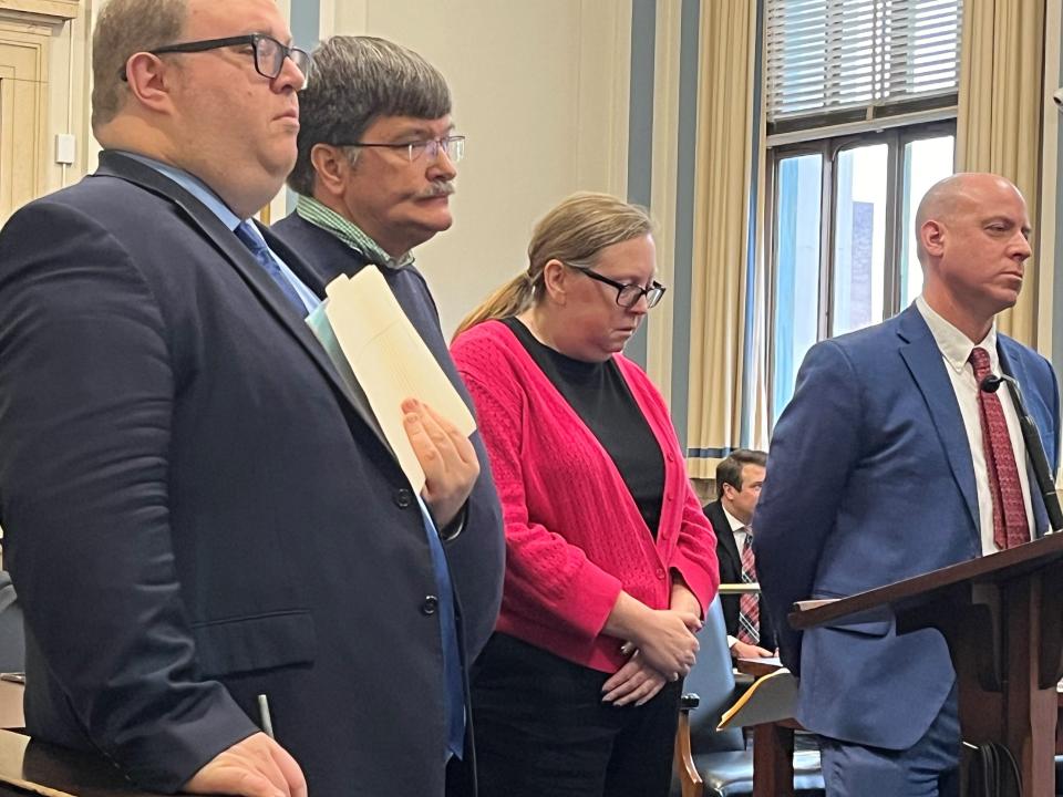 Michael and Nancy Trubl stand between their attorneys, Josh Hitch (at left) and Brian Goldberg (at right), during their sentencing in Hamilton County Common Pleas Court on Tuesday, Jan. 30, 2024. Each pleaded guilty to stealing nearly $41,000 from an organization that raised money for arts programs at Winton Woods schools.