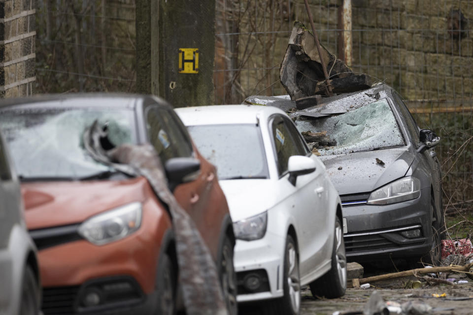 STALYBRIDGE, ENGLAND - DECEMBER 28: Damaged cars are seen outside a home following a tornado on December 28, 2023 in Stalybridge, England. Houses in the Tameside area of Greater Manchester have been damaged by a localised tornado during Storm Gerrit. Police declared a major incident last night as roofs were torn off the houses and trees uprooted, but no reported injuries. (Photo by Ryan Jenkinson/Getty Images)