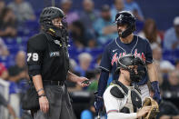 Atlanta Braves' Dansby Swanson, right, reacts to a call by home plate umpire Manny Gonzalez (79) during the eighth inning of a baseball game against the Miami Marlins, Monday, Oct. 3, 2022, in Miami. (AP Photo/Wilfredo Lee)