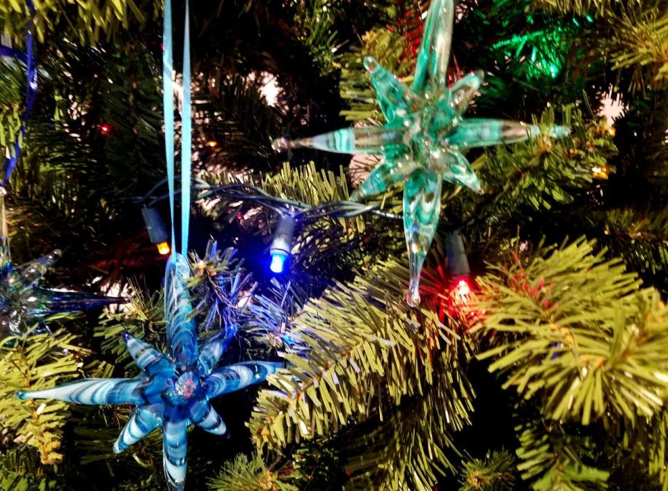 The annual Glassblowers' Christmas display at Sandwich Glass Museum, with glass-blown ornaments hung on Christmas trees, is part of the Holly Days celebration.