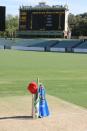 The West End Redbacks place a bat, cap and shirt in the middle of the Adelaide Oval.