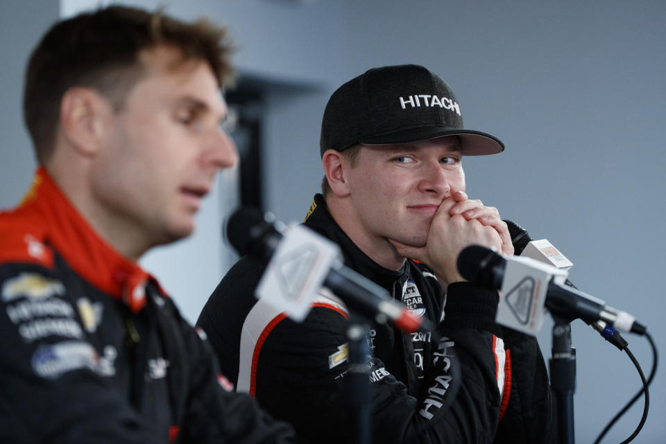 Josef Newgarden, right, listens to Will Power speak during a news conference for Sunday's IndyCar Series auto race at Pocono Raceway, Saturday, Aug. 17, 2019, in Long Pond, Pa. (AP Photo/Matt Slocum)