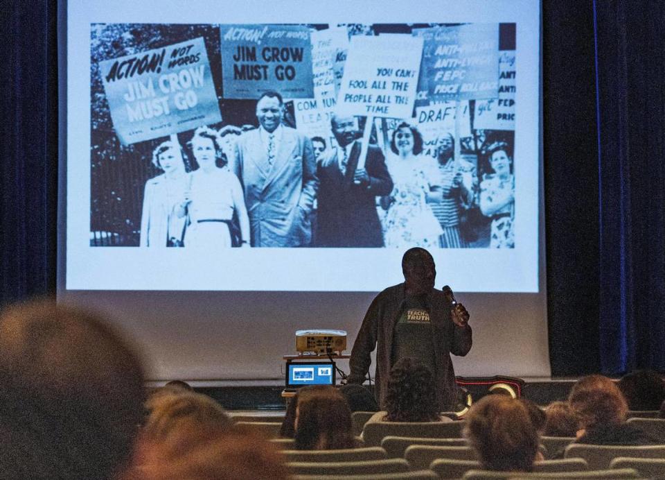 Historian Marvin Dunn shows photos from the Civil Rights Movement to local students during a presentation.