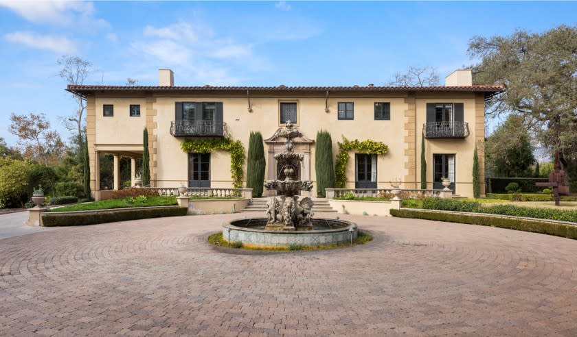 Built in 1929 by Wallace Neff, the Italian Revival-style residence features hand-painted ceilings, antique chandeliers and marble floors.