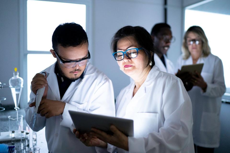 Researchers work in a lab.