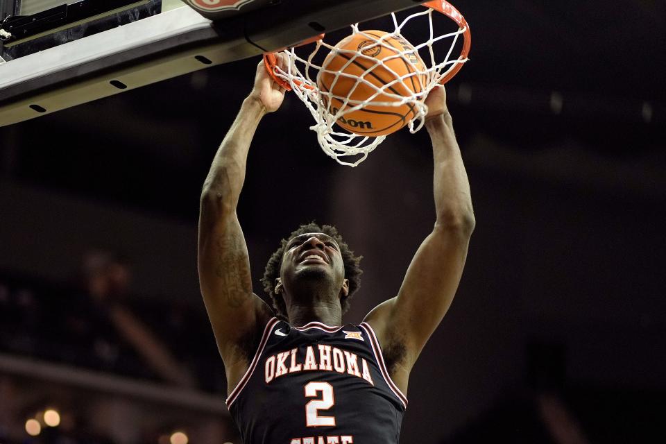 Oklahoma State forward Eric Dailey Jr. dunks the ball during the first half of an NCAA college basketball game against UCF Tuesday, March 12, 2024, in Kansas City, Mo. (AP Photo/Charlie Riedel)