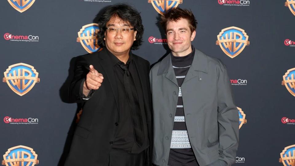 LAS VEGAS, NEVADA - APRIL 09: (L-R) Bong Joon-ho and Robert Pattinson attend the Warner Bros. Pictures Presentation during CinemaCon 2024 at The Colosseum at Caesars Palace on April 09, 2024 in Las Vegas, Nevada.