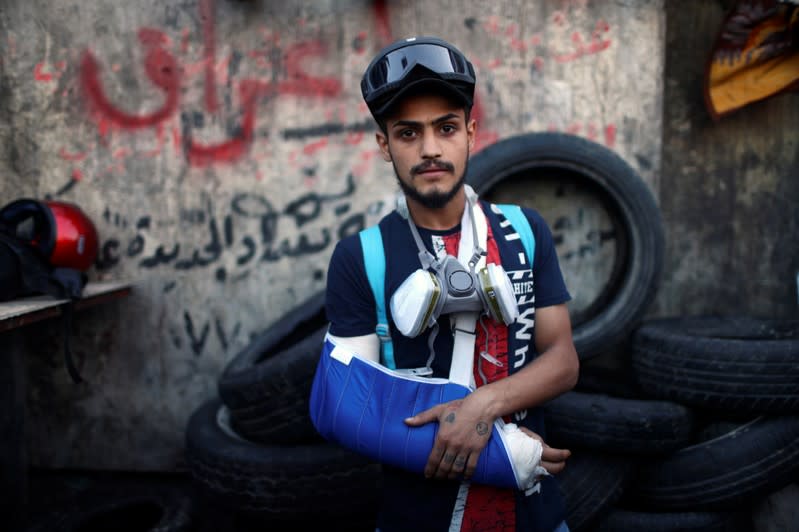 Mohammad Said Yasseen, an Iraqi demonstrator, poses for a photograph during the ongoing anti-government protests in Baghdad