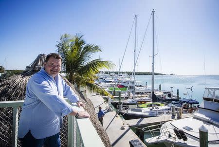 Former Air Force C-130 pilot, Brian Hall, a businessman who wants to start 4-hour round trip service between Marathon in the Florida Keys and Havana, poses for or a picture in the the Marathon Marina in Marathon, Florida February 20, 2015. REUTERS/Mark Blinch