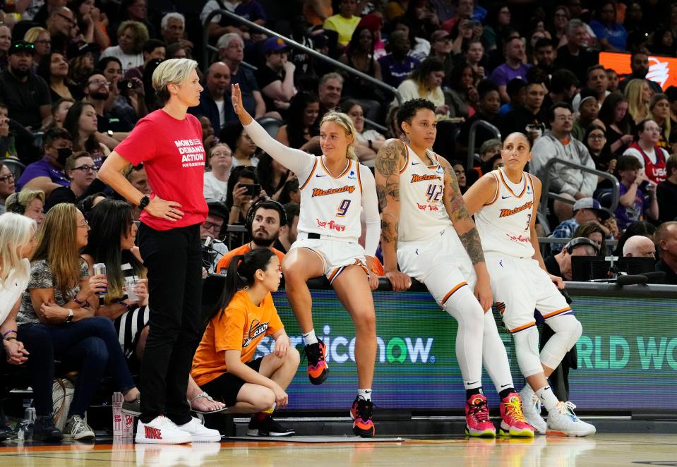 Phoenix Mercury guard Sophie Cunningham (9), center Brittney Griner (42), and guard Diana Taurasi (3) wait to check into the game against the Los Angeles Sparks on June 2, 2023, at the Footprint Center in Phoenix.