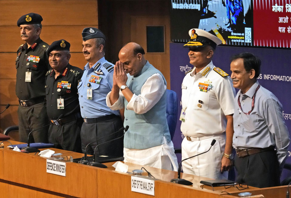 Indian Defence Minister Rajnath Singh greets the media with Indian Army chief General Manoj Pande, second left, Indian Air Force Chief Air Chief Marshal V R Chaudhari, third left, and Indian Naval Chief Admiral R. Hari Kumar, second right, by his side after the launch of Agnipath Scheme, in New Delhi, Tuesday, June 14, 2022. The Agnipath is a merit based recruitment scheme for enrolling soldiers, airmen and sailors. The Scheme provides an opportunity for the youth to serve in the regular cadre of the armed forces for a duration of four years. (AP Photo/Manish Swarup)