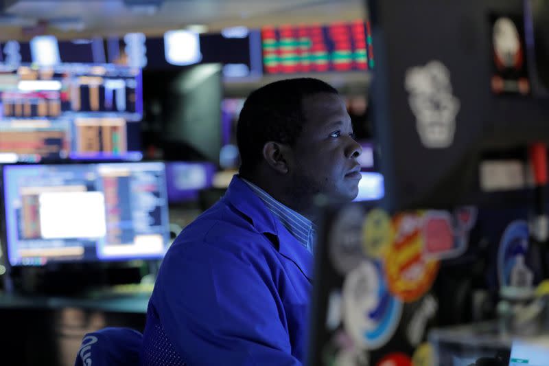 A trader works on the trading floor after the closing bell at the New York Stock Exchange (NYSE) in New York City