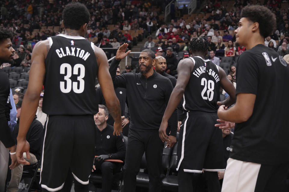 Brooklyn Nets interim head coach Kevin Ollie, center, prepares his team before an NBA basketball game against the Toronto Raptors in Toronto, Thursday, Feb. 22, 2024. (Chris Young/The Canadian Press via AP)