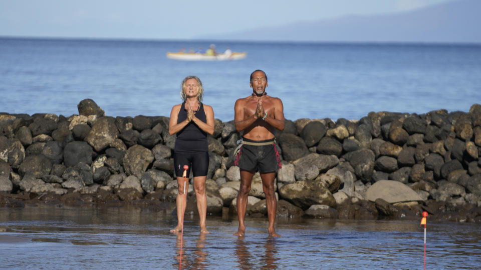 CORRECTS LAST NAME TO RUBIO, NOT RUBOI - Vicente, right, and Ewa Rubio perform a blessing to greet the day on the beach Tuesday, Aug. 15, 2023, in Kihei, Hawaii. (AP Photo/Rick Bowmer)