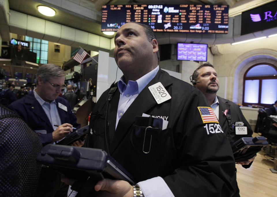 Anthony Riccio, center, work with fellow traders on the floor of the New York Stock Exchange Friday, June 1, 2012. Stocks fell sharply Friday after the release of a dismal report on job creation in the United States. The Dow Jones industrial average dropped more than 200 points, erasing what was left of its gain for the year. (AP Photo/Richard Drew)