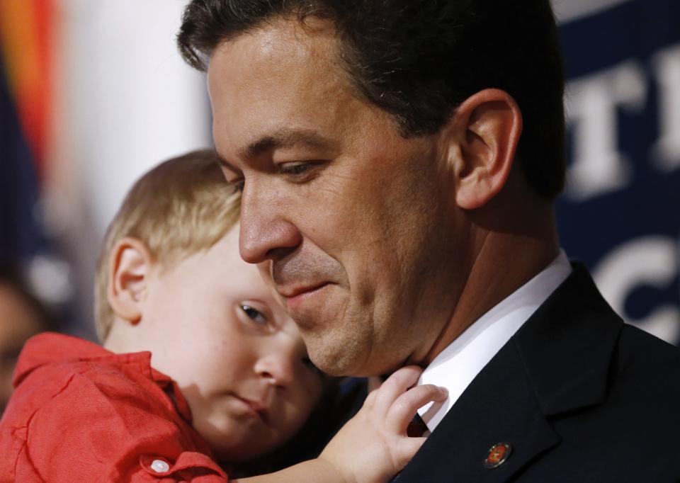 Tea Party candidate Chris McDaniel holds his son, Chamberlain, 2, after he delivered a concession speech in Hattiesburg, Mississippi, June 24, 2014. U.S. Senator Thad Cochran of Mississippi narrowly defeated challenger McDaniel on Tuesday in a high-profile runoff election that pitted the Republican Party establishment against the insurgent Tea Party movement. (REUTERS/Jonathan Bachman)