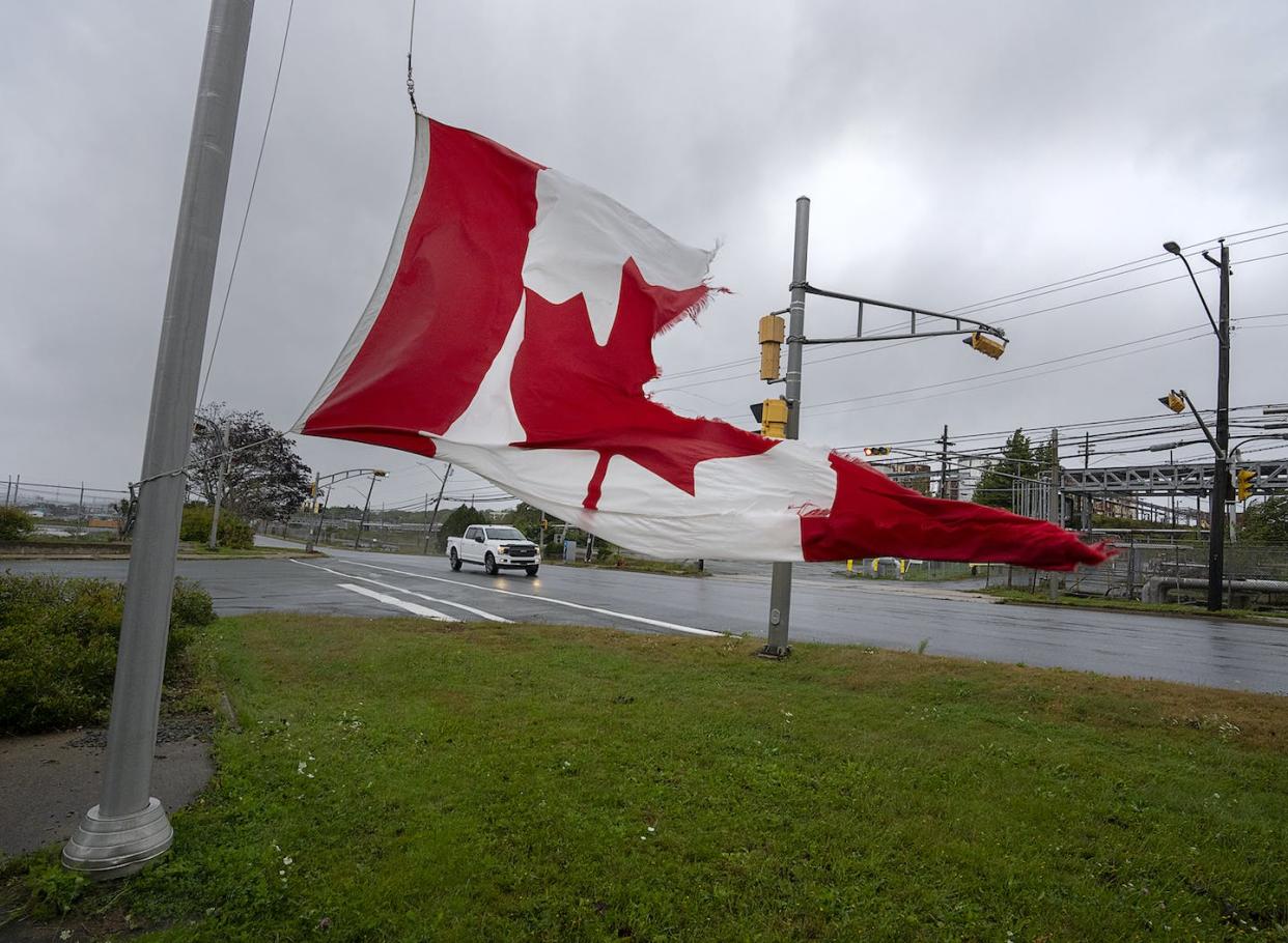 A Canadian flag waves in the high winds in Dartmouth, N.S. on Sept. 24, 2022. THE CANADIAN PRESS/Andrew Vaughan