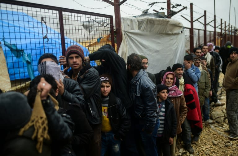 Syrian refugees wait for aid in Bab al-Salama, near the city of Azaz, northern Syria, near the Turkish border crossing, on February 6, 2016